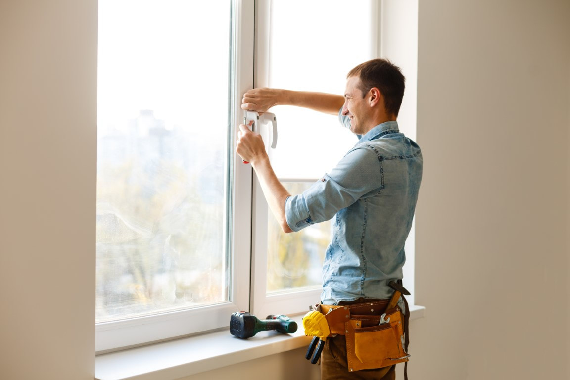 An image of a person working on a hurricane proof window protection