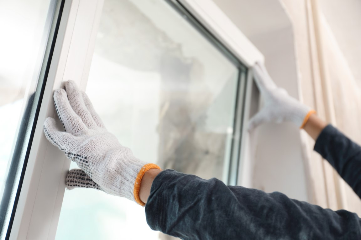 An image of a person installing hurricane proof glass window
